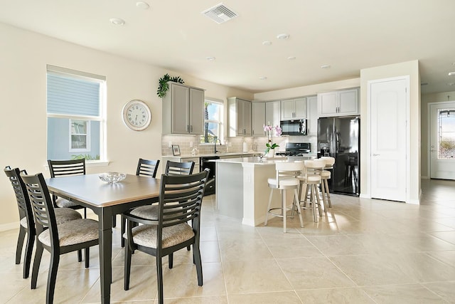 tiled dining room with sink