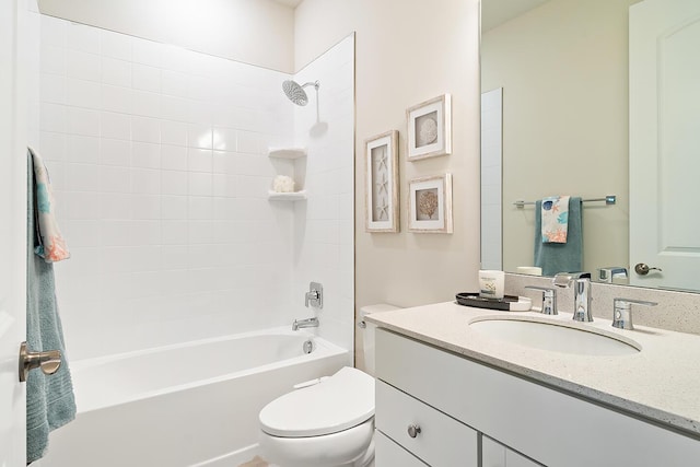 full bathroom featuring vanity, tiled shower / bath combo, and toilet