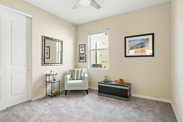 sitting room featuring ceiling fan and light colored carpet