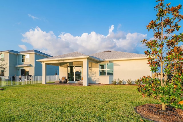 back of property featuring a lawn and a patio