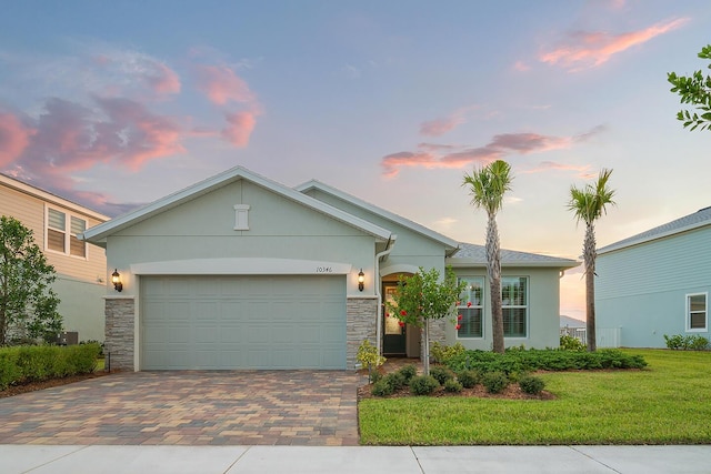 view of front of home with a lawn and a garage