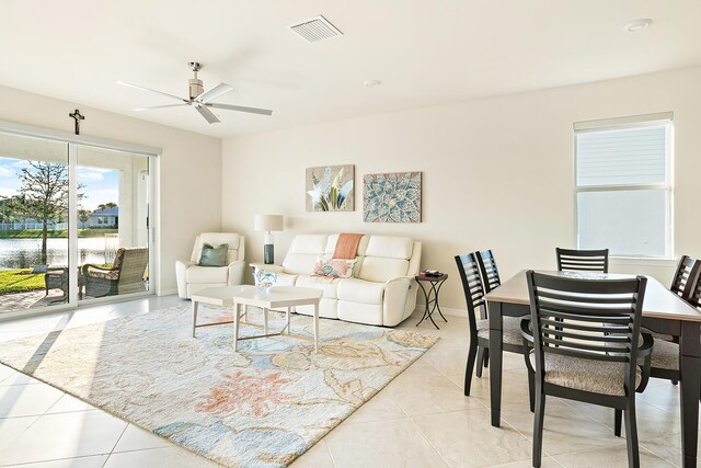 living room with ceiling fan and light tile patterned floors