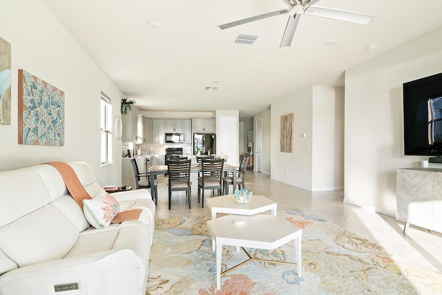 living room featuring ceiling fan and light tile patterned floors