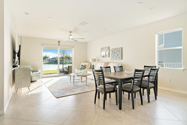 dining area with ceiling fan and light tile patterned floors