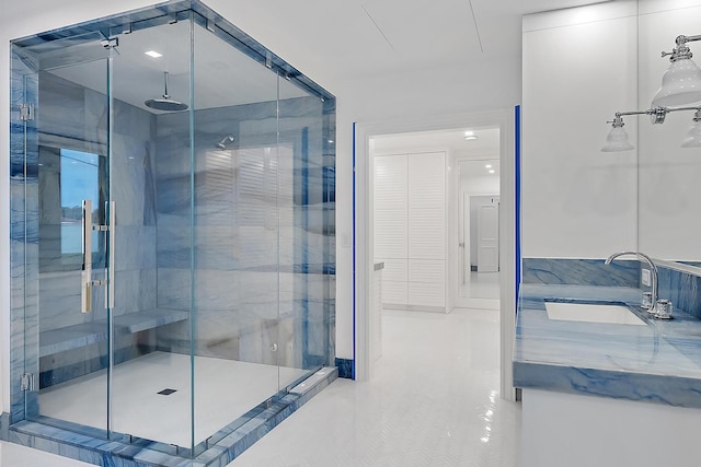 bathroom featuring vanity and an enclosed shower