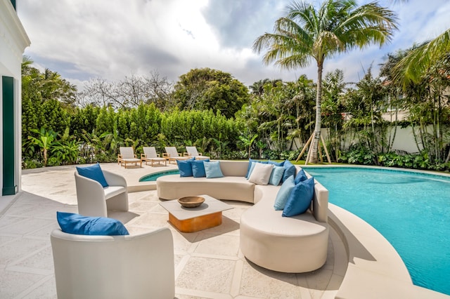 view of swimming pool featuring a patio area, an outdoor living space with a fire pit, a fenced in pool, and fence