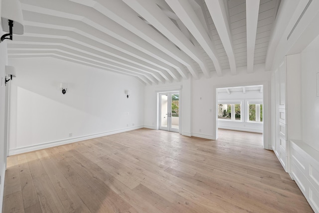 unfurnished living room with french doors, baseboards, lofted ceiling with beams, and light wood finished floors