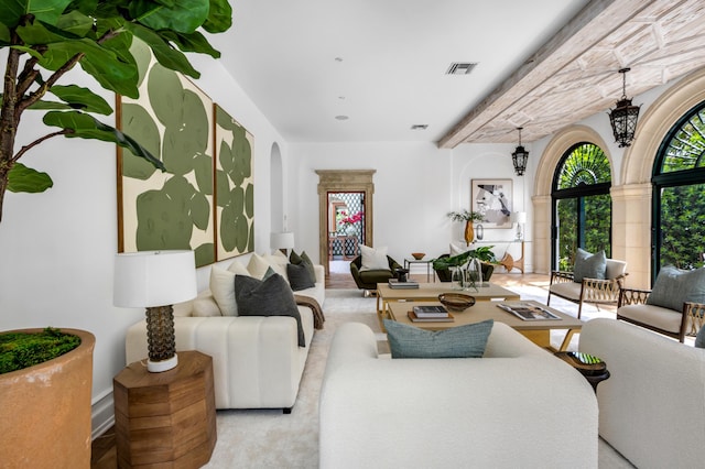 living room with visible vents and arched walkways