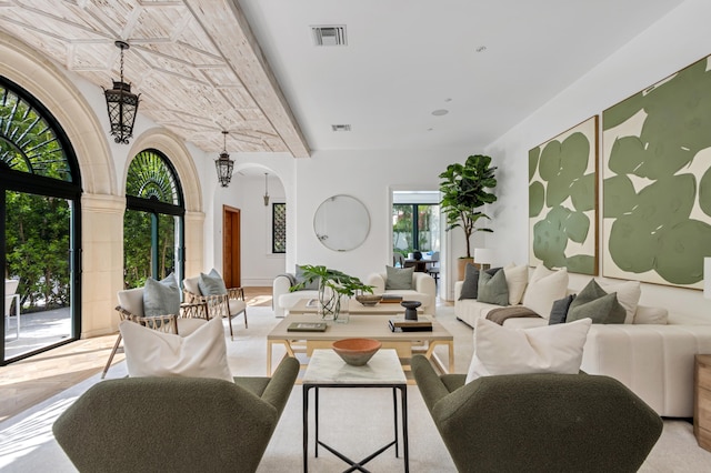 living room featuring visible vents and arched walkways