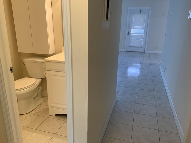 bathroom featuring tile patterned flooring, vanity, and toilet