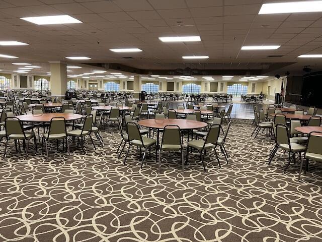 dining area with carpet flooring and a drop ceiling