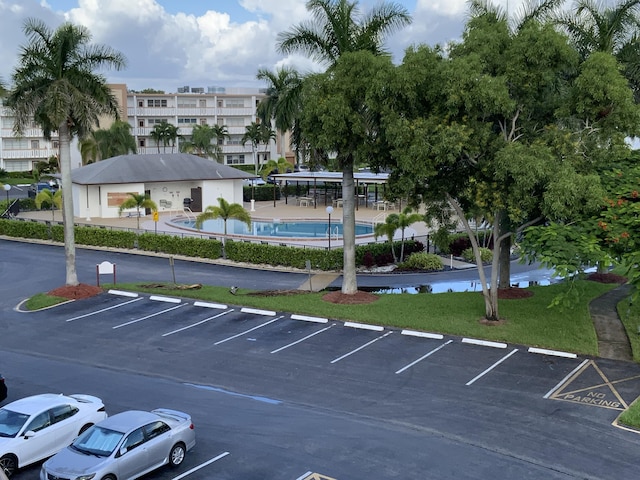 1011 Guildford A 1011, Boca Raton, FL 33434 - uncovered parking lot with a community pool