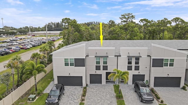 view of front of property featuring a garage and central air condition unit