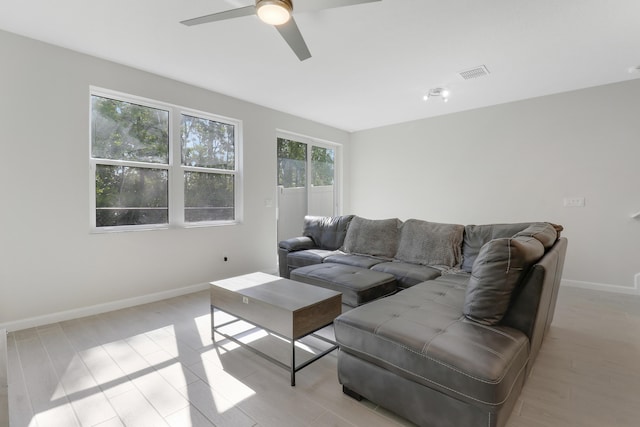 living room featuring ceiling fan and light hardwood / wood-style flooring