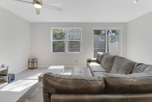 living room with ceiling fan and light hardwood / wood-style flooring