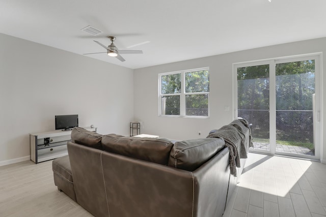 living room featuring ceiling fan and light hardwood / wood-style flooring