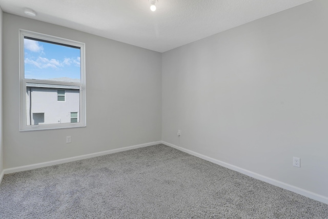 unfurnished room with carpet flooring