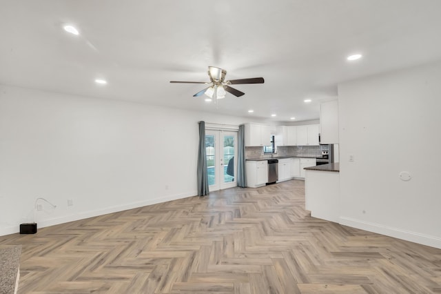 kitchen featuring dishwasher, decorative backsplash, white cabinetry, and light parquet floors