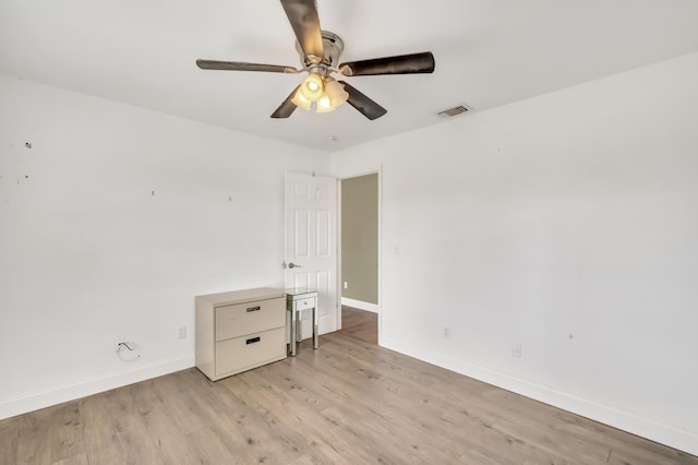 spare room with light hardwood / wood-style floors and ceiling fan