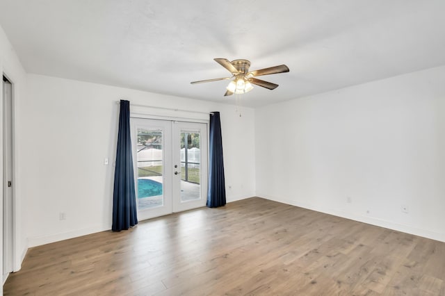 empty room featuring hardwood / wood-style flooring, ceiling fan, and french doors