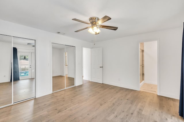 unfurnished bedroom with multiple closets, ceiling fan, and light hardwood / wood-style flooring