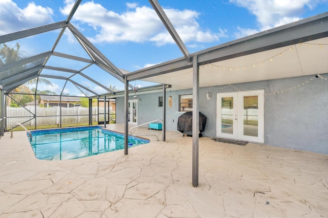 view of pool featuring a grill, a lanai, a patio, and french doors