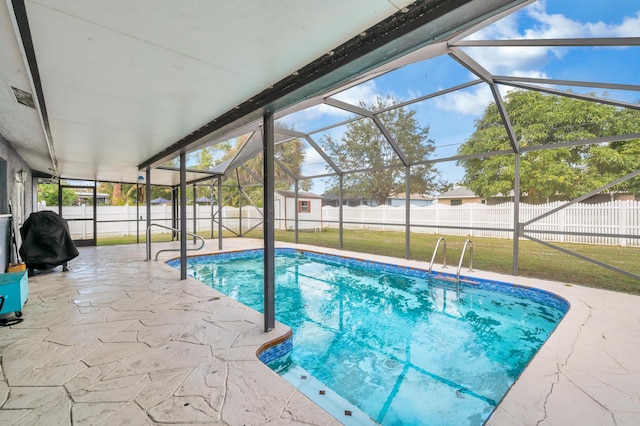 view of pool featuring a yard, a patio, and a lanai