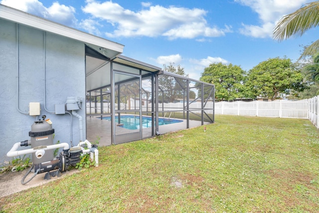 view of yard with a fenced in pool and glass enclosure