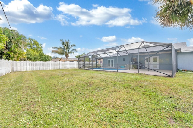 view of yard with a lanai and a fenced in pool