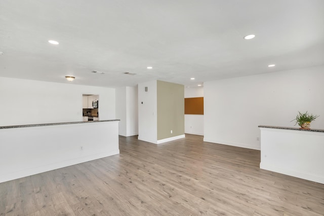 unfurnished living room with light hardwood / wood-style floors