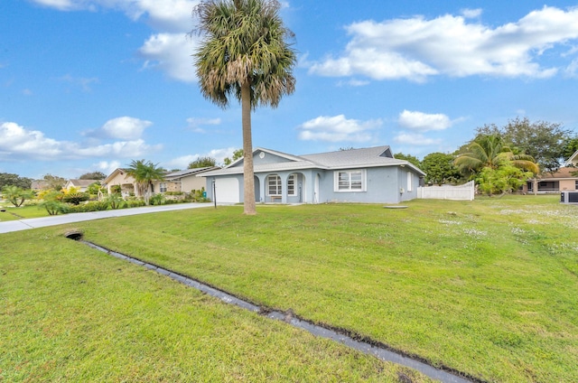 single story home featuring a garage and a front yard