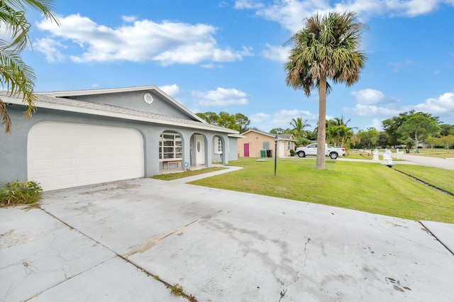 single story home with a front yard and a garage