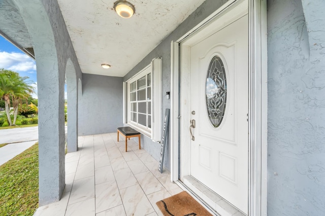 property entrance with covered porch