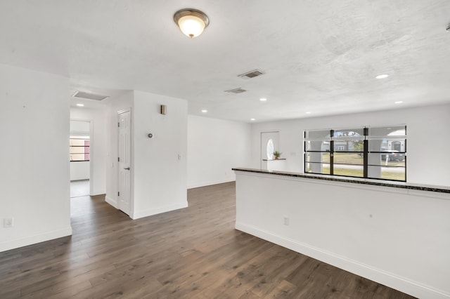 unfurnished room with dark hardwood / wood-style flooring