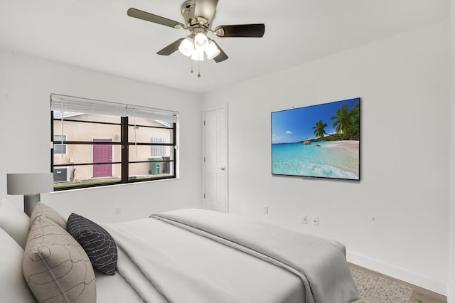 bedroom with ceiling fan and hardwood / wood-style flooring