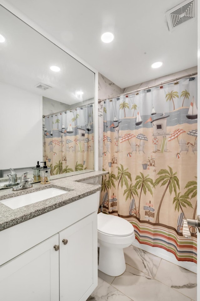 bathroom with a shower with shower curtain, vanity, and toilet