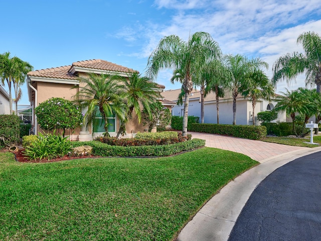 mediterranean / spanish house featuring a front lawn