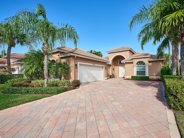 mediterranean / spanish home featuring a garage