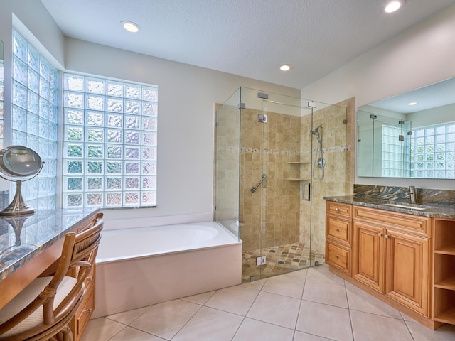 bathroom with tile patterned flooring, vanity, and independent shower and bath