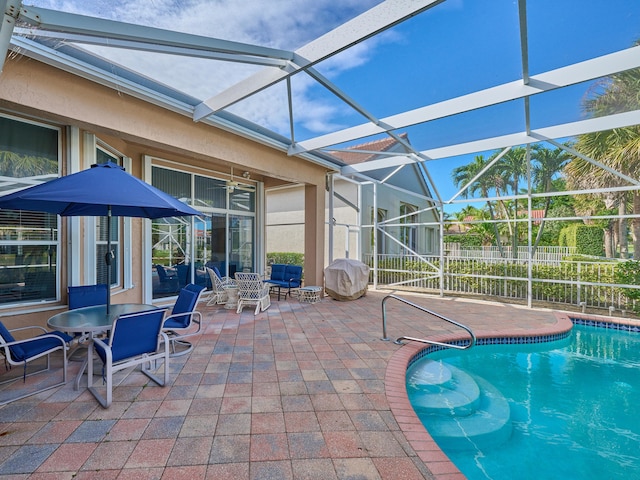 view of swimming pool featuring a lanai and a patio