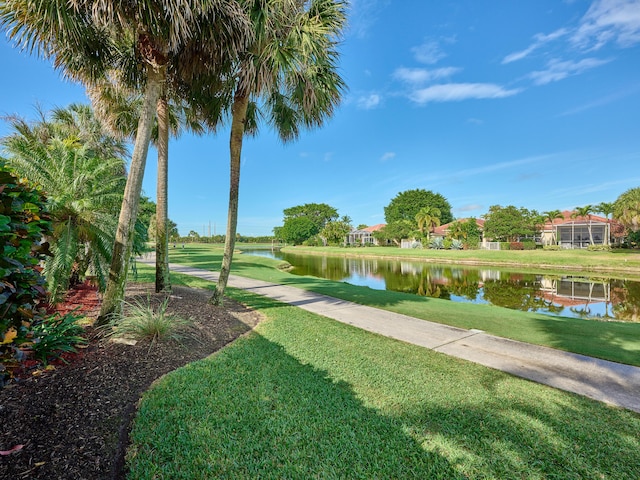 view of property's community featuring a yard and a water view