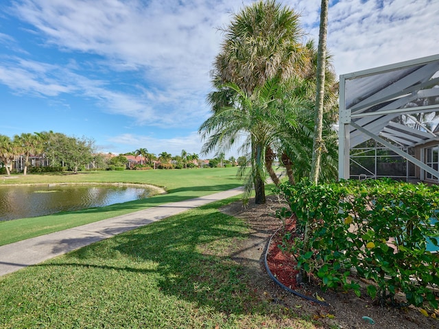 view of home's community with a yard and a water view