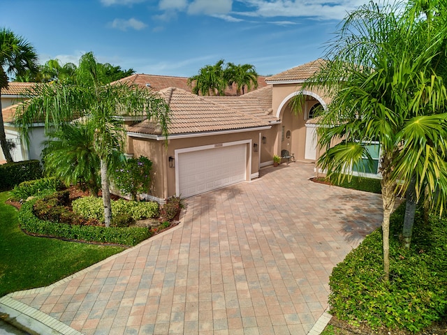 mediterranean / spanish house featuring a garage