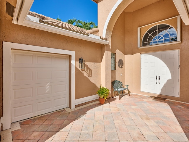 view of exterior entry featuring a garage