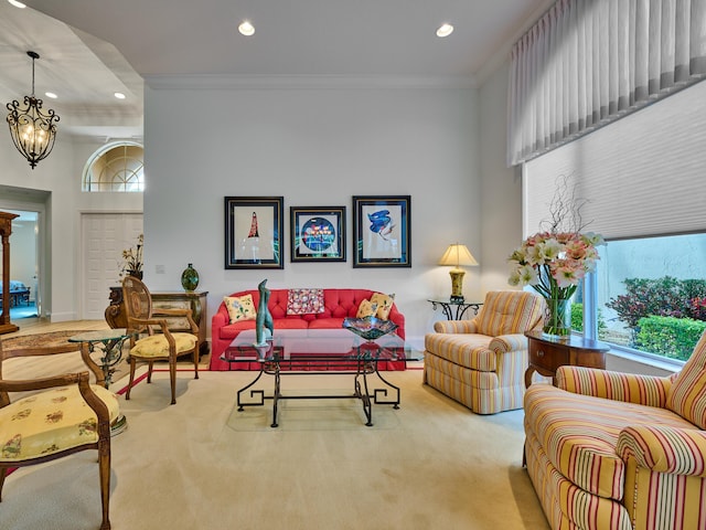 living room with a chandelier, light carpet, and crown molding