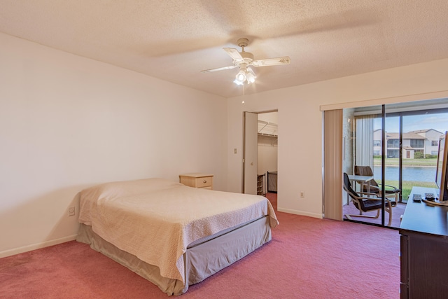 bedroom featuring access to outside, ceiling fan, a spacious closet, carpet floors, and a closet