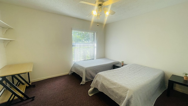 carpeted bedroom featuring a textured ceiling and ceiling fan