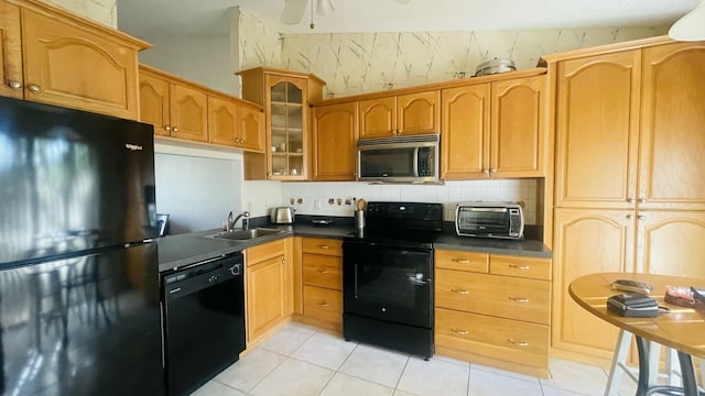 kitchen featuring black appliances, ceiling fan, light tile patterned floors, and sink