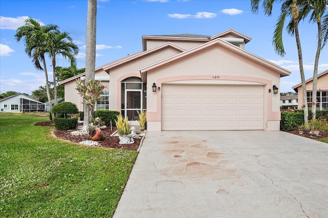 view of front of property featuring a front yard and a garage