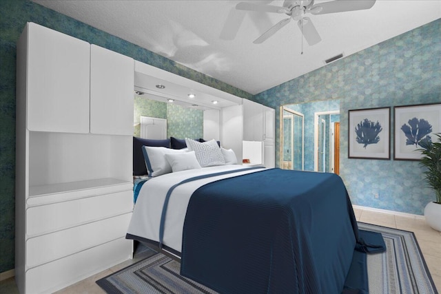 tiled bedroom featuring a textured ceiling, vaulted ceiling, and ceiling fan